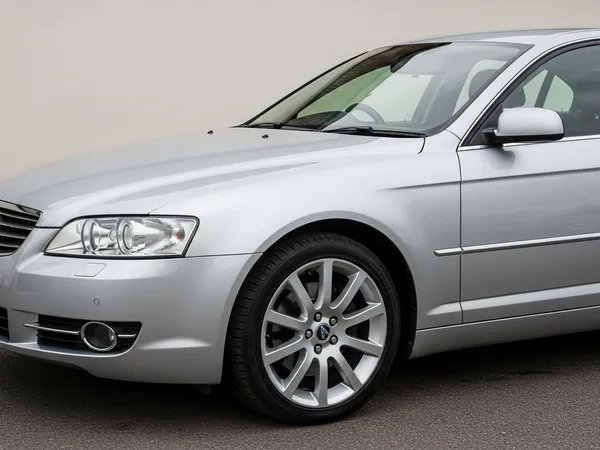 Vehicle transport documentation photo 4: Passenger side front corner of silver car showing front bumper, headlight, front door panel and alloy wheel for car shipping records