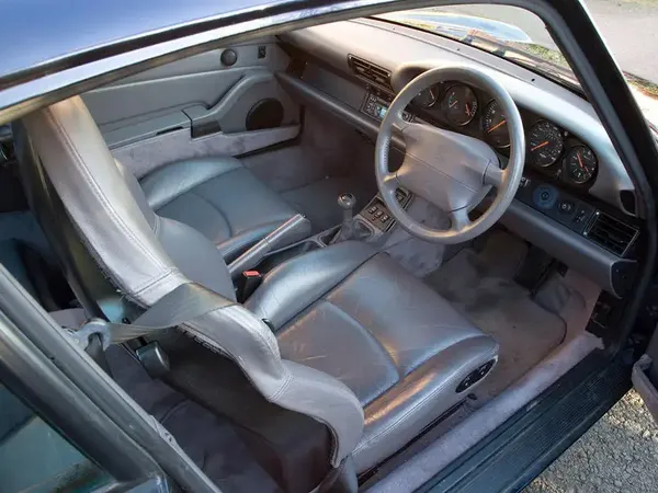 Vehicle transport documentation photo 5: UK right-hand drive car interior viewed from driver's door showing steering wheel, dashboard, seats and mileage for vehicle delivery condition record