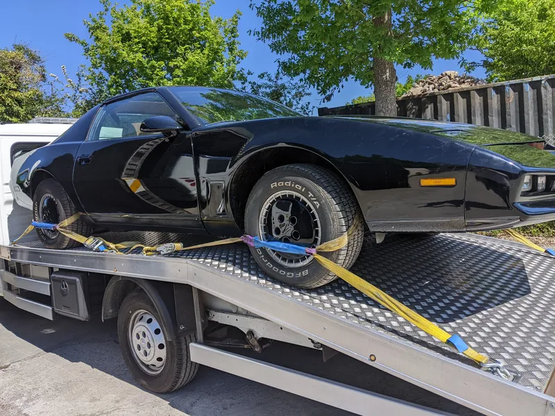 Classic black Corvette strapped and secured on MotorMoves transporter for safe UK vehicle delivery